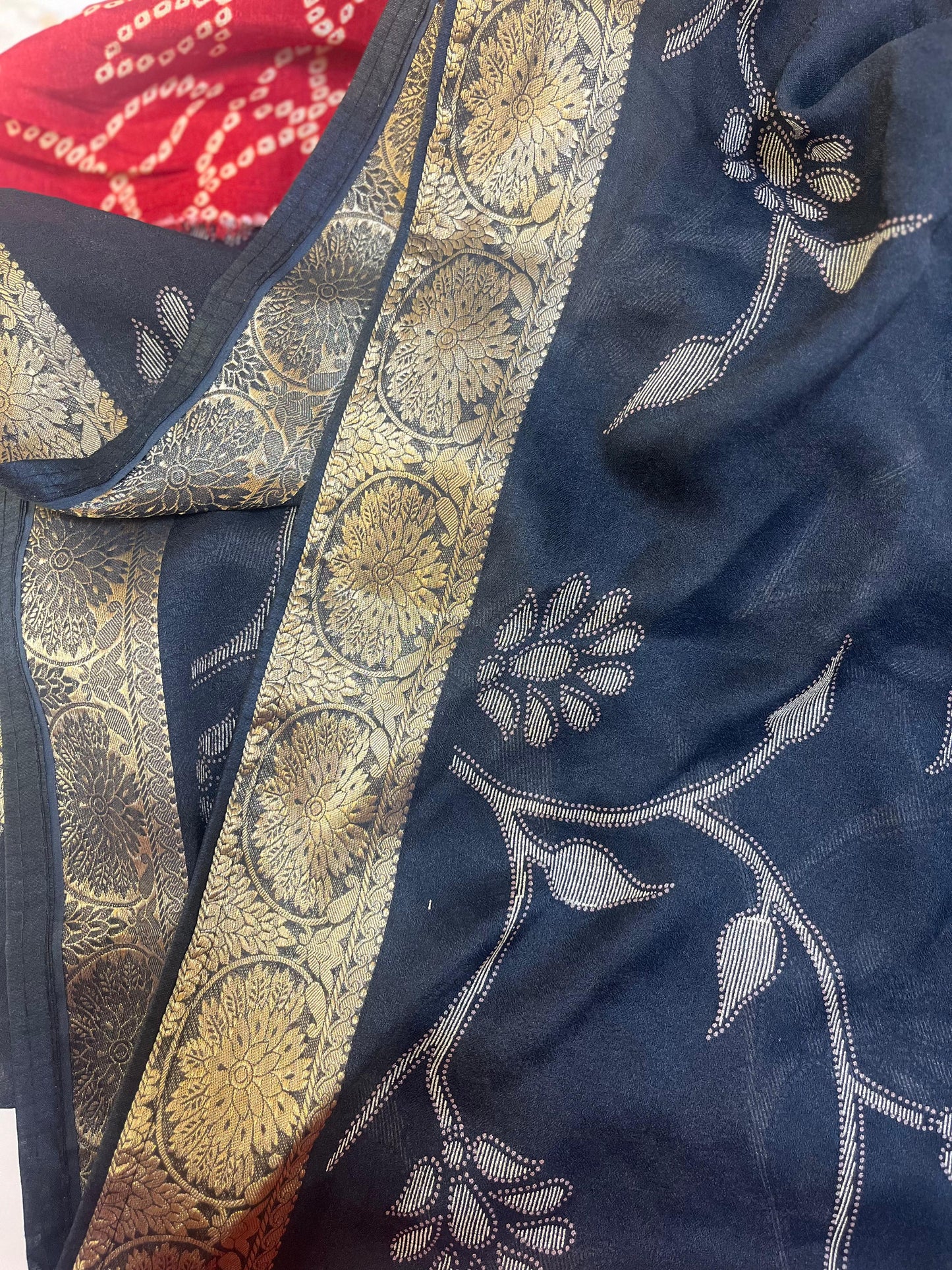 Navy blue fabric with gold and white floral patterns