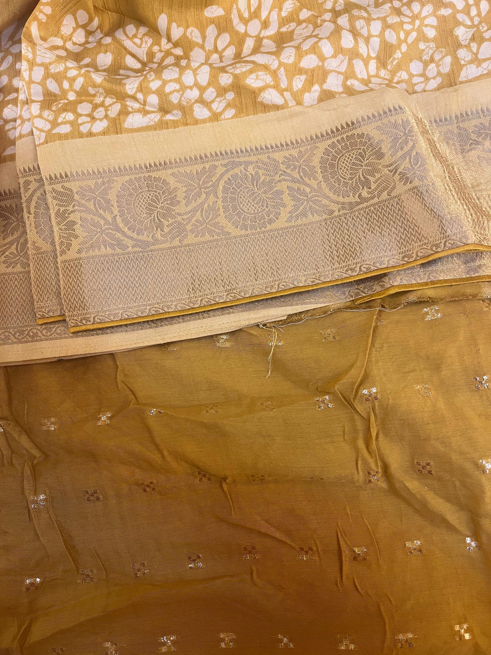 Close-up of a yellow saree with floral patterns
