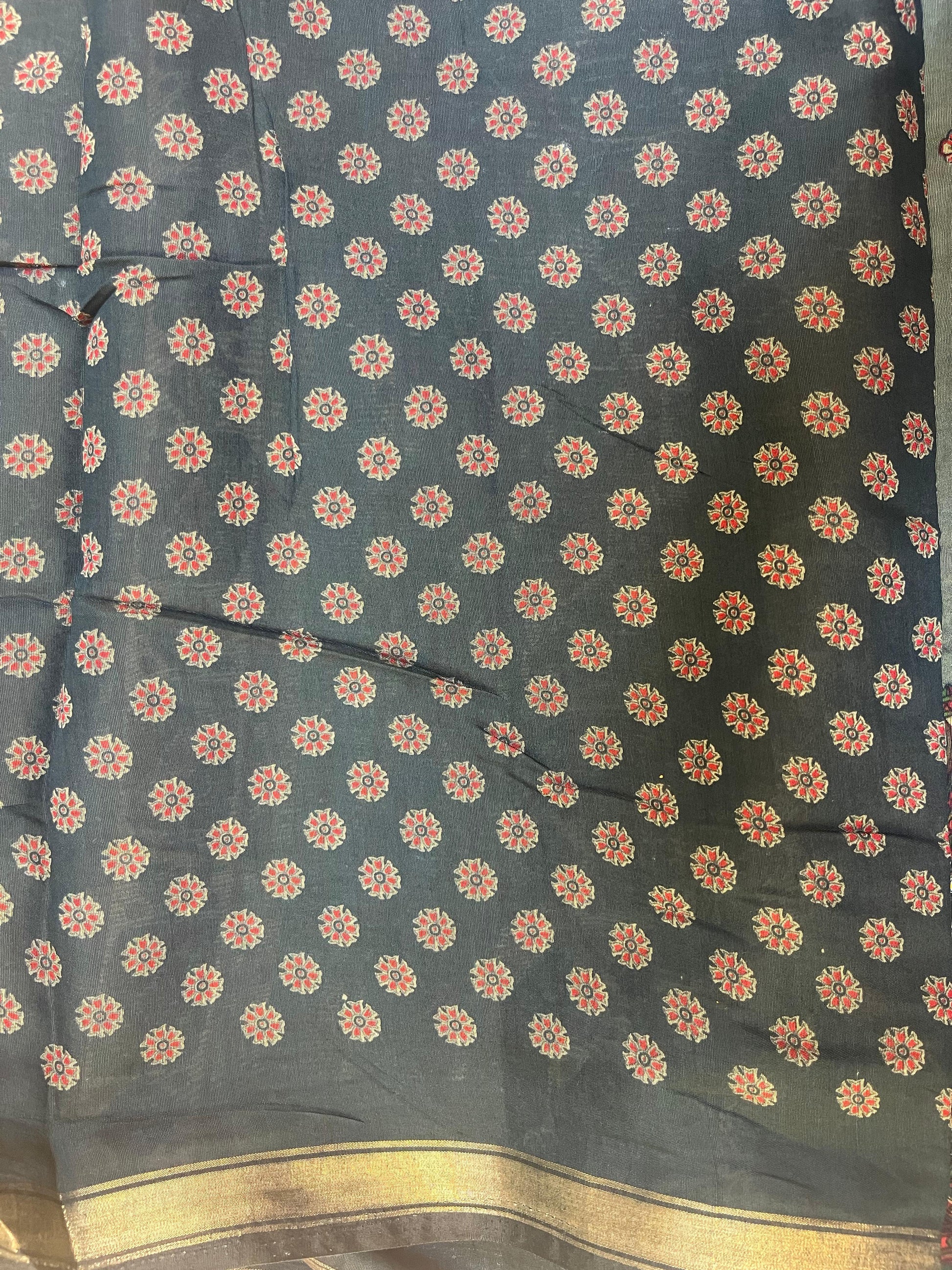 Dark fabric with small floral pattern and gold border